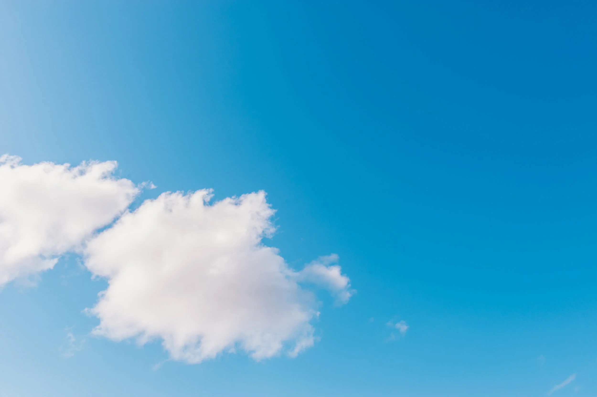 Matte gouache-style painting of a soft blue sky with airy white clouds drifting in the lower left, calm and open mood